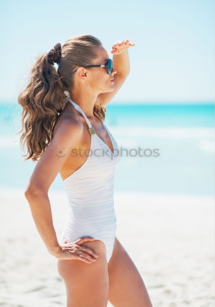 Similar – Image, Stock Photo Beautiful young woman posing on the sand in the beach