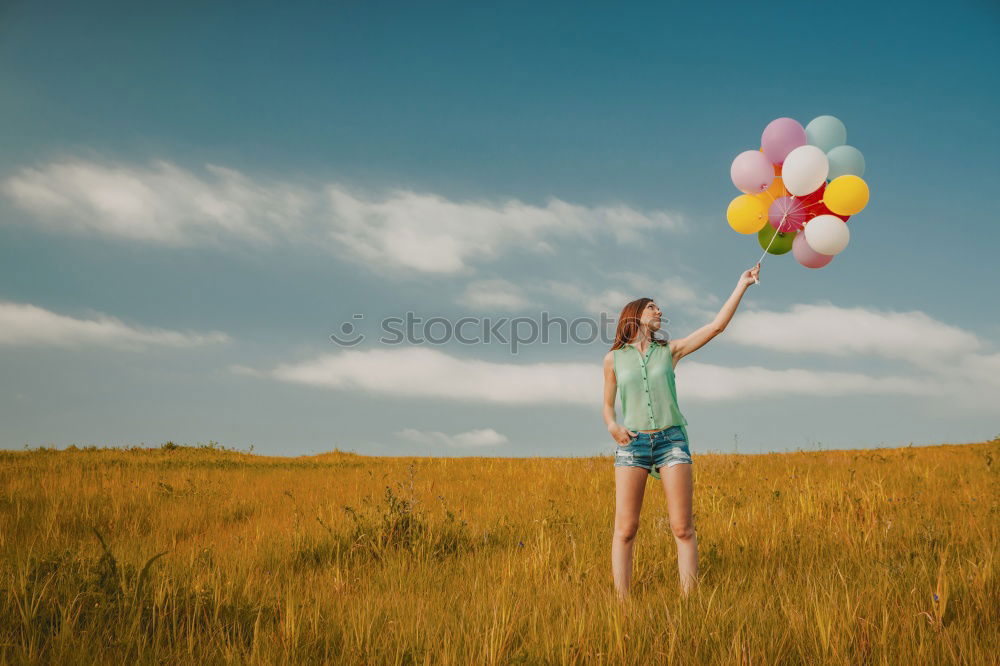 Similar – young woman with balloon on the mountain at a city