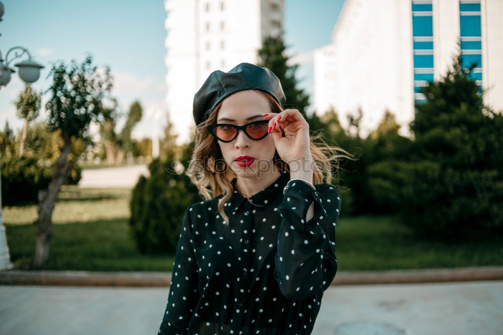 Similar – Young brunette woman wearing sunglasses