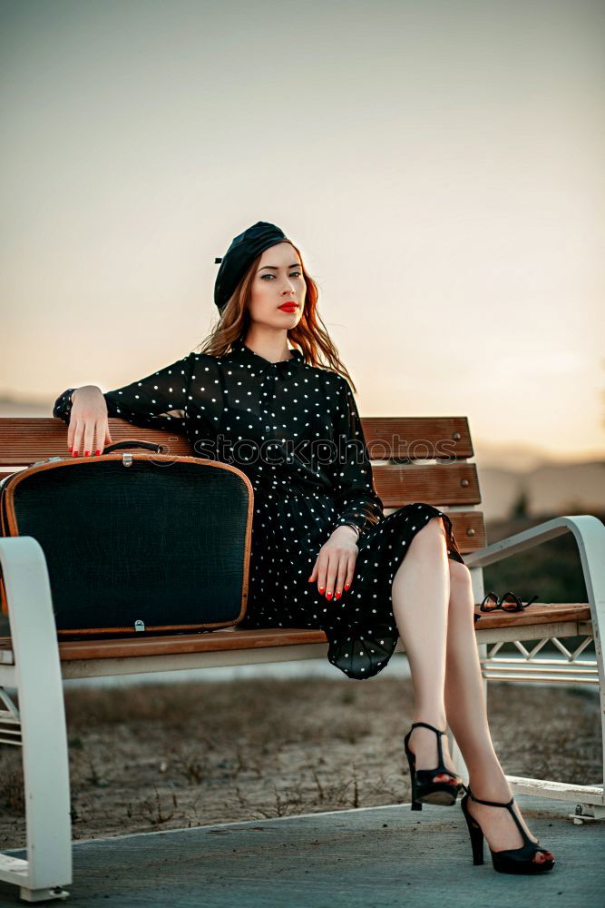 Similar – Young woman sitting on the street