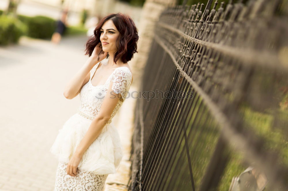 Similar – Image, Stock Photo Pensive bride with a red suitcase on the train tracks
