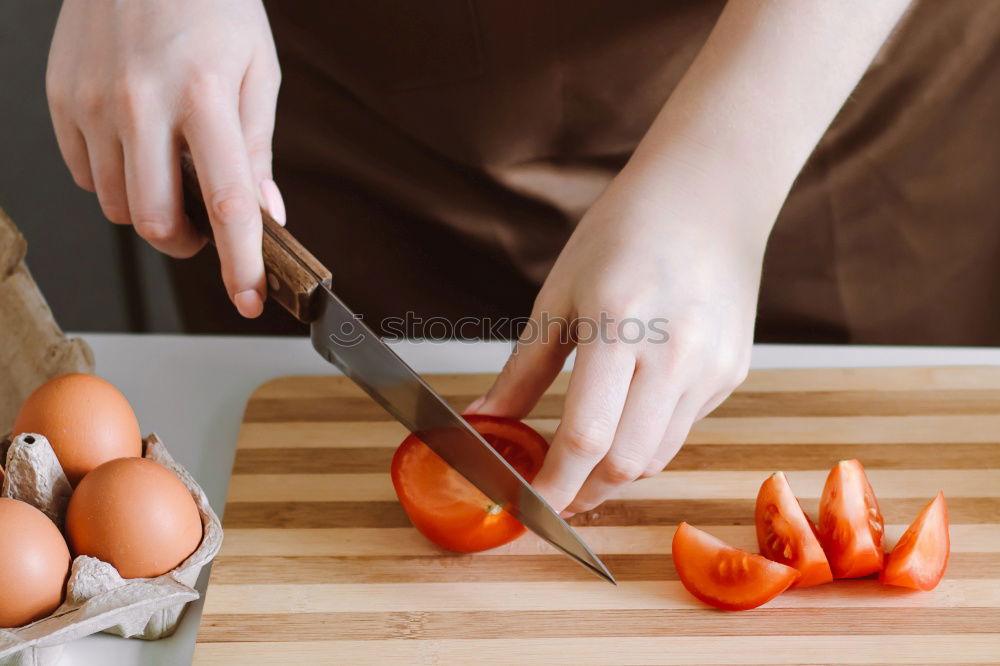 Similar – process of slicing carrots on slices on a kitchen board