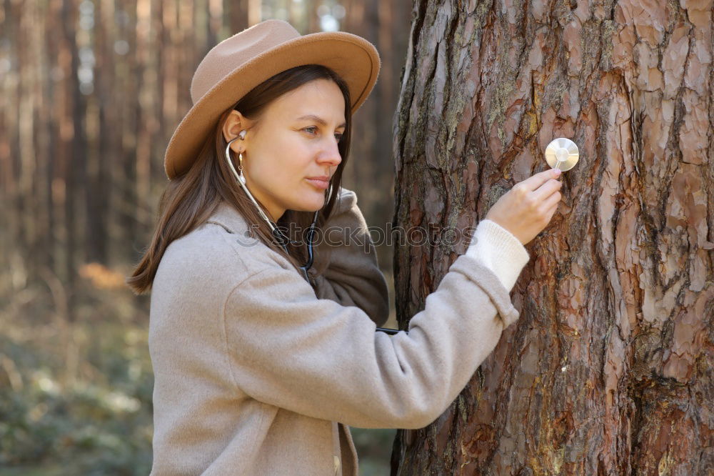 Similar – Image, Stock Photo Woman with knitted hat and coat hugs a tree, dreaming in nature.