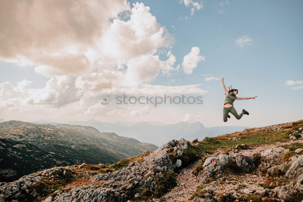 Similar – Tourist jumping over gorge