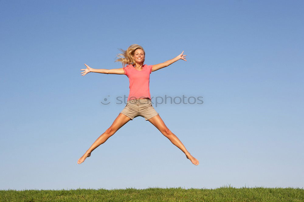 Similar – Young girl in jumpsuit with flower pattern jumps to the left in front of blue sky