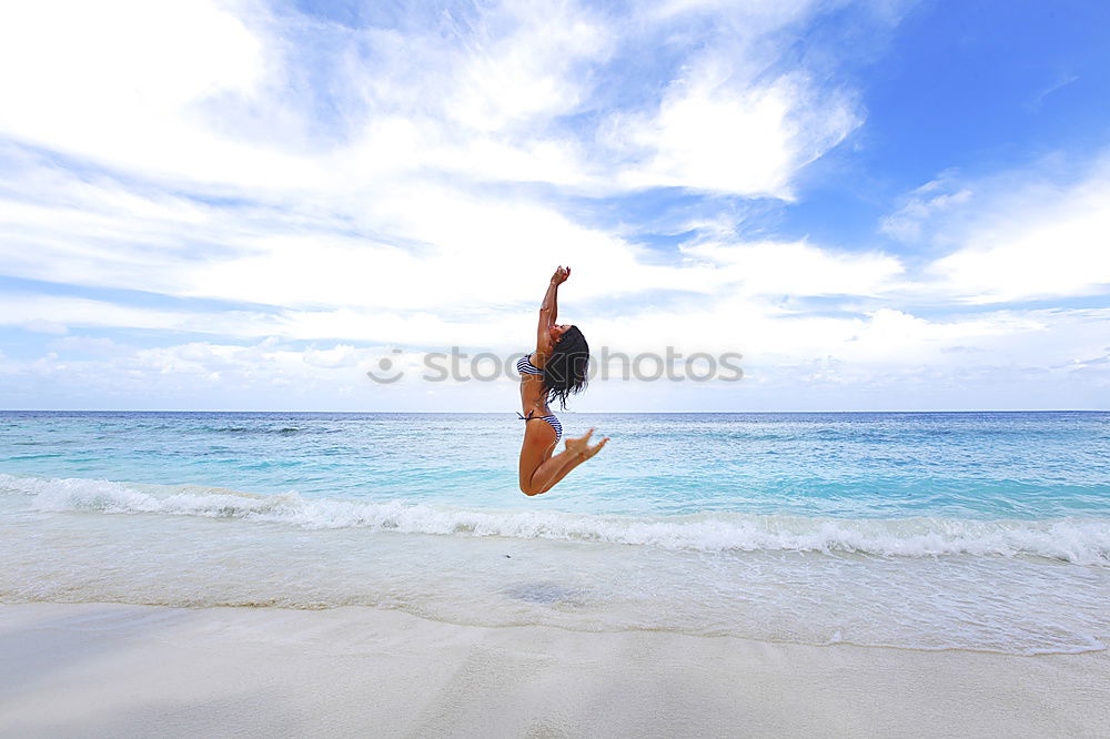 Similar – Happy teen girl jumping on the beach