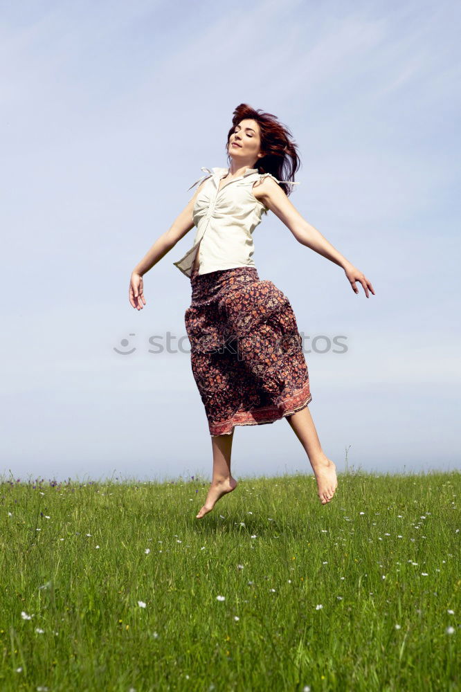 Similar – young woman jumps for joy with outstretched arms towards the sky