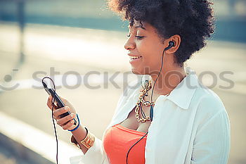 Black woman listening to the music with headphones