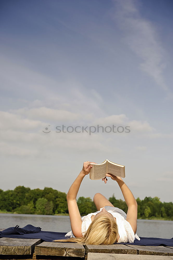 Similar – Image, Stock Photo Girl lying on a blanket and reading a book on a sunny day