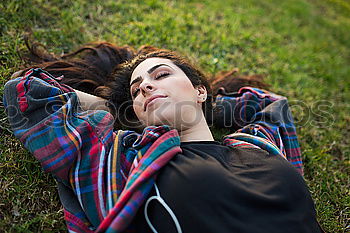 Similar – Image, Stock Photo Young woman lying down over a field of grass and pollen