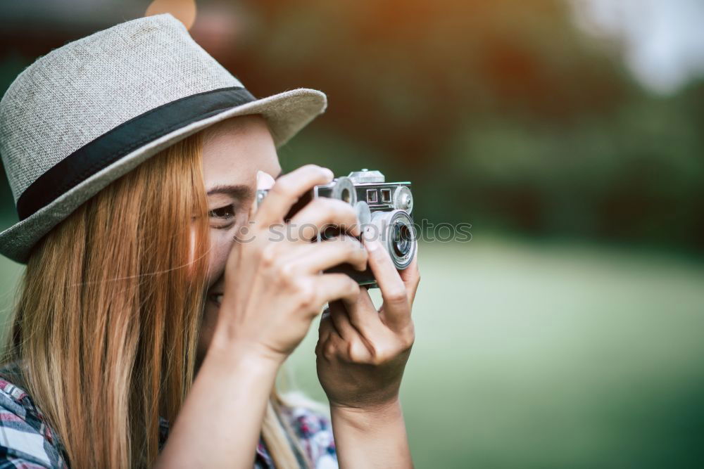 Similar – Young redhead woman taking shots with her analog camera