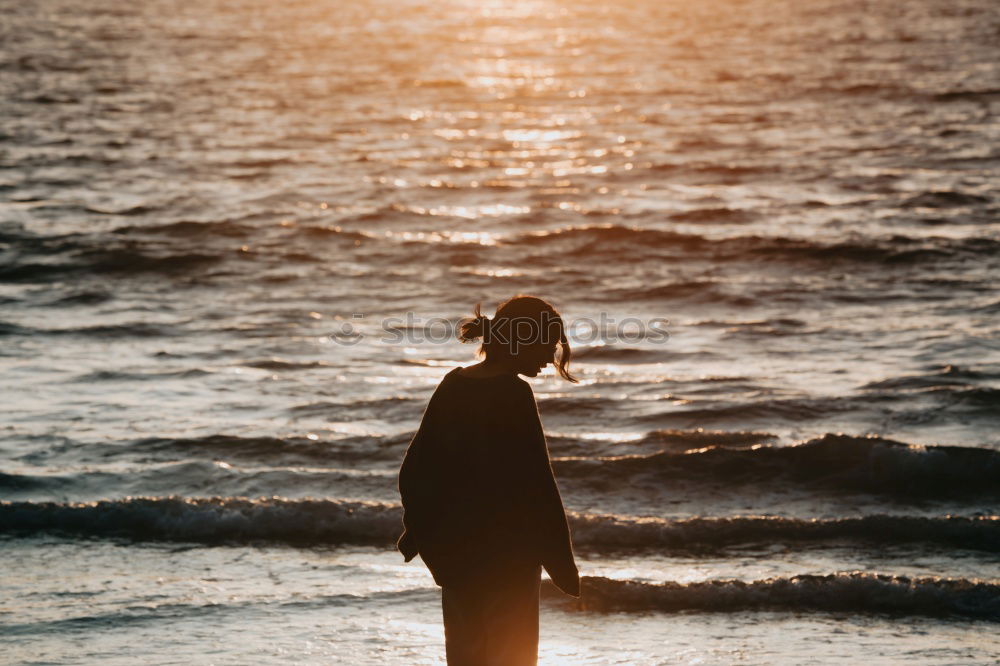 Image, Stock Photo Young woman is taking picture of sunset at the beach