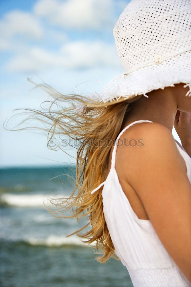 Similar – Young woman in a hat facing the beach