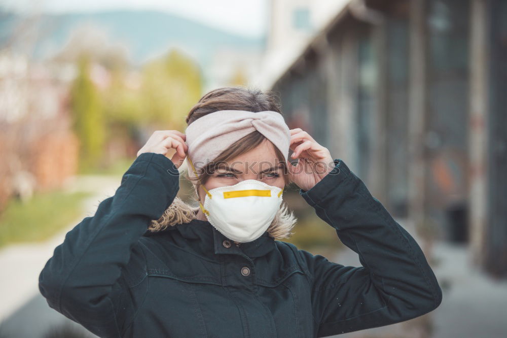 Similar – young woman wearing a mask and fogged glasses in autumn / winter (Corona / Covid-19)