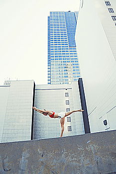 Similar – Woman jumps barefoot on blue rubber hills into the air with outstretched arms