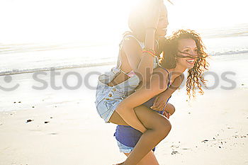 Similar – Image, Stock Photo Two young adult girlfriends chatting at beach and laughing