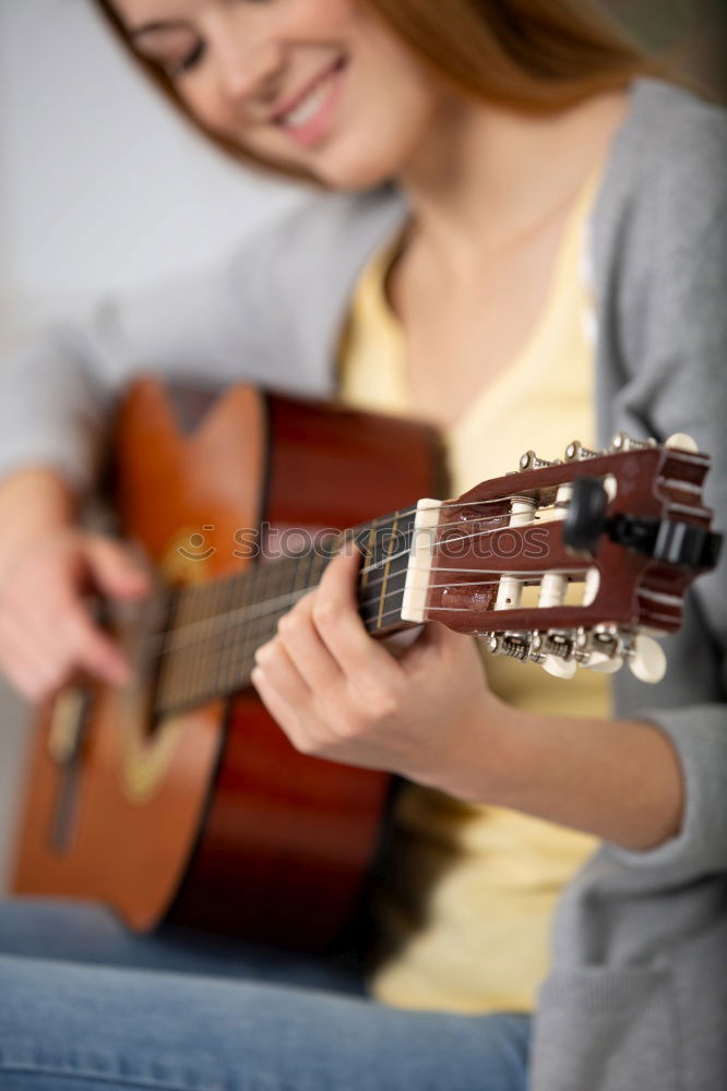 Beautiful woman playing guitar.