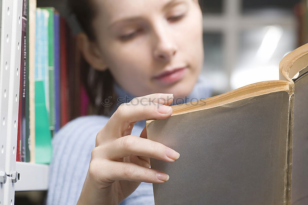 Similar – Young woman putting old books to paper bag in antique bookstore