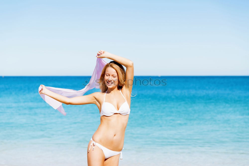 Similar – Young woman in bikini on a tropical beach with open arms.