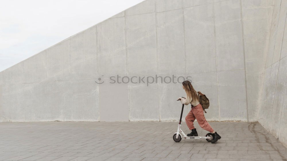 Similar – Image, Stock Photo elegantly dressed lady with black coat, red hat, red scarf and red pumps walks on a large square with concrete and patterned floor