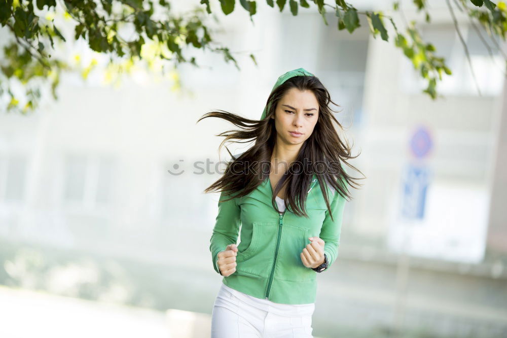 Similar – Young woman with moving hair wearing casual clothes