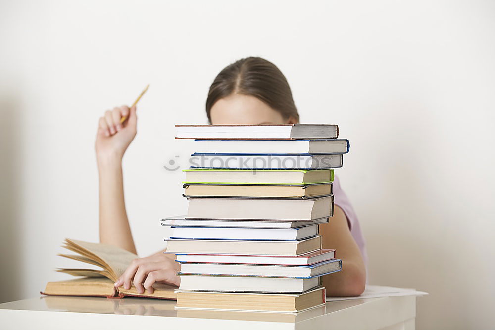 Similar – Young woman putting old books to paper bag in antique bookstore