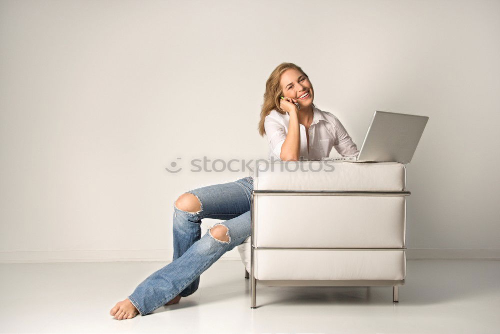 Similar – Smiling businesswoman with magazine and crossed legs sitting chair against of modern wall