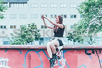 Similar – Woman jumping barefoot over blue rubber hills