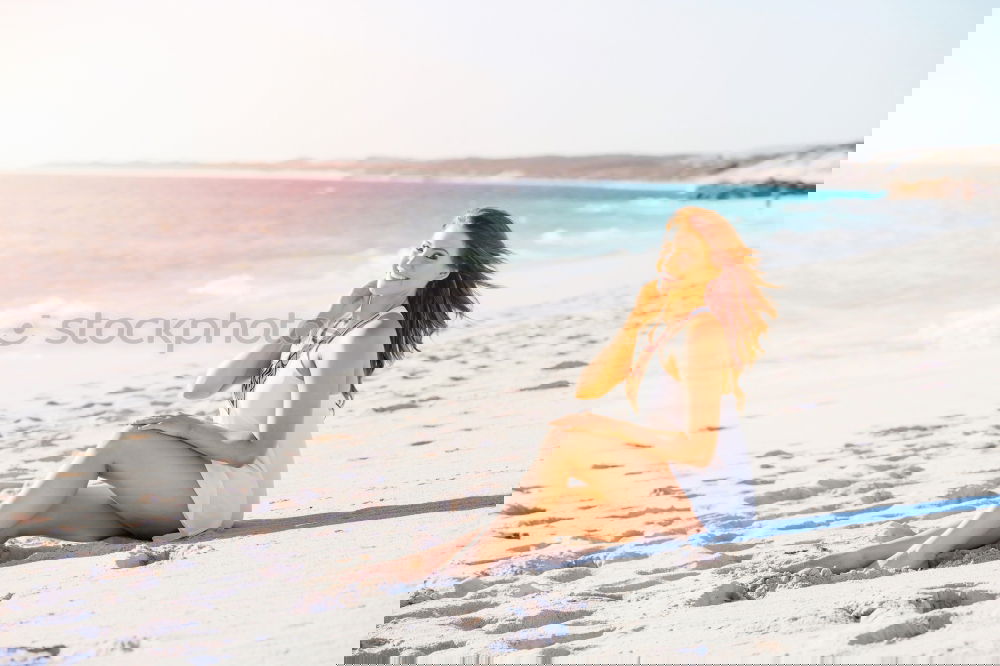 Similar – Image, Stock Photo Beautiful young woman posing on the sand at the beach