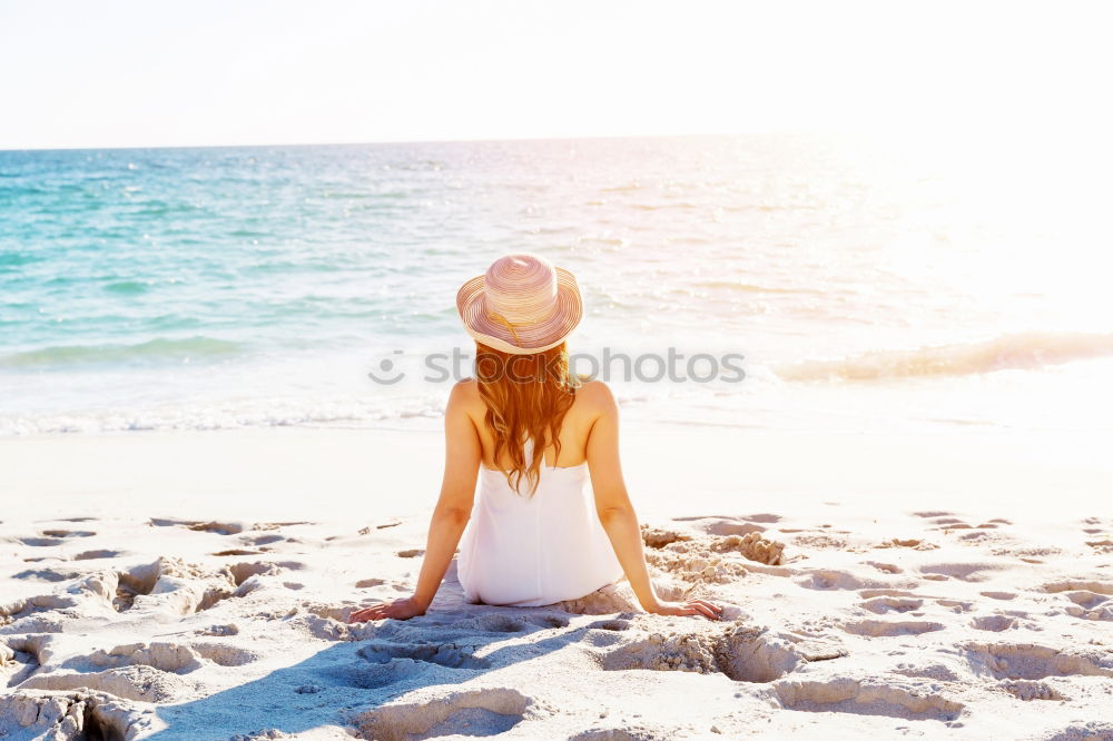 Similar – Image, Stock Photo Woman with hat on wooden trail on the beach in the morning