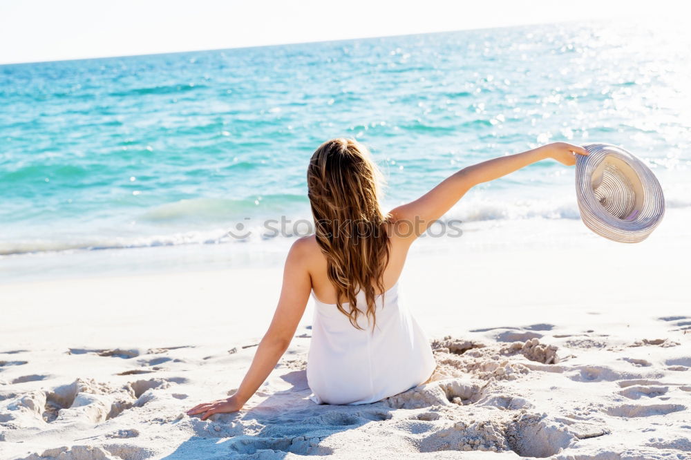 Similar – Young woman in a hat facing the beach