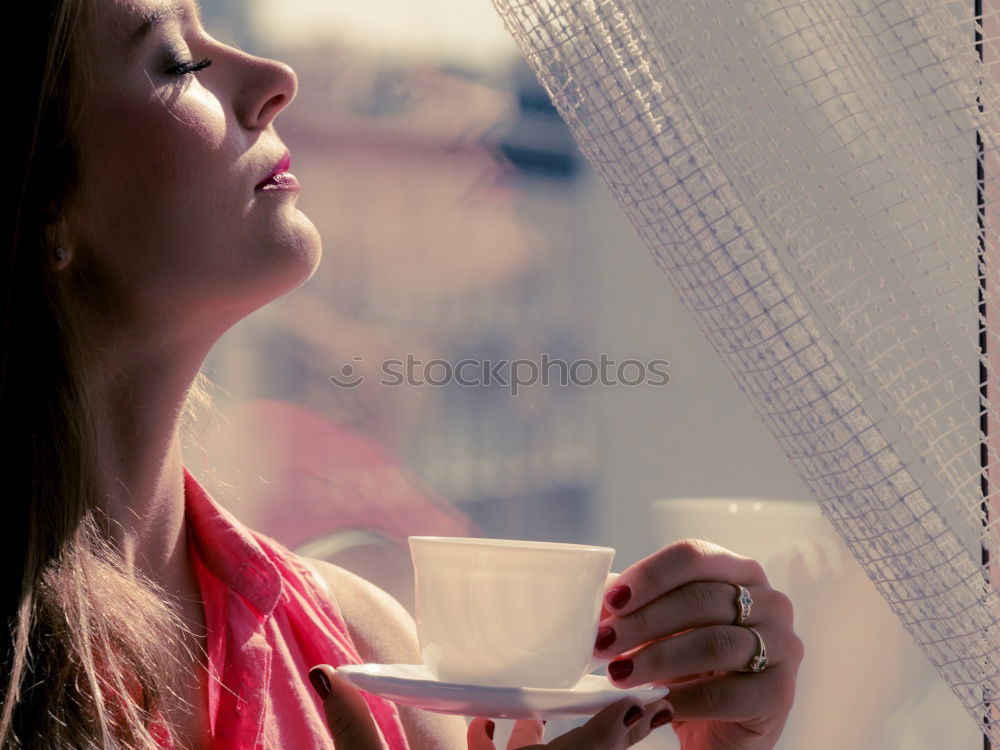 beauty girl sitting in a coffee shop with a cup in her hands