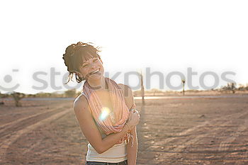 Similar – beautiful girl with short haircut and wearing black clothes in countryside enjoying the sunset