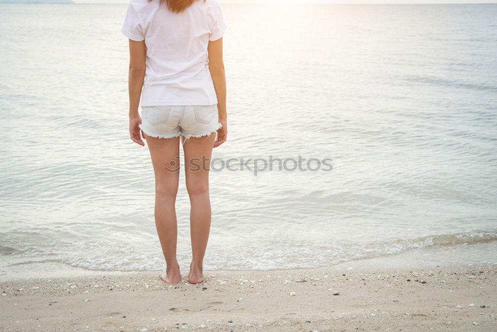 Similar – Asian woman standing on the terrace and looking around the sea.