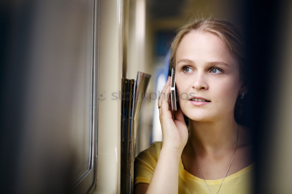 Similar – young, redheaded woman with curls looks out of the balcony window