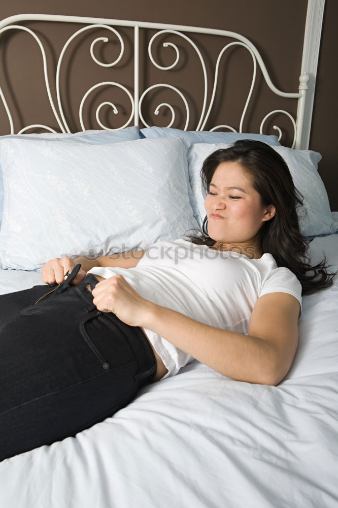 Cheerful woman lying with book