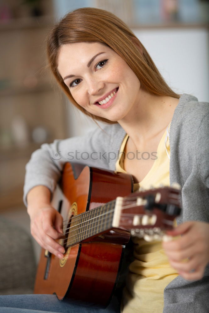 Similar – Beautiful woman playing guitar.