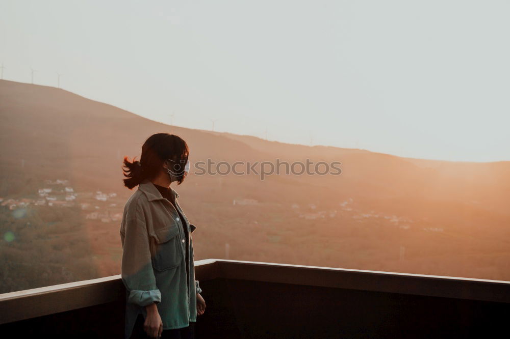 Thoughtful woman at lamp post