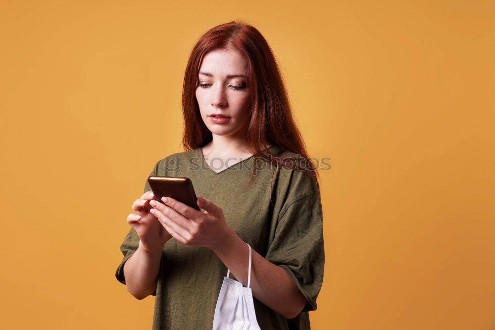 Similar – Portrait of beautiful young woman using mobile phone in the street.