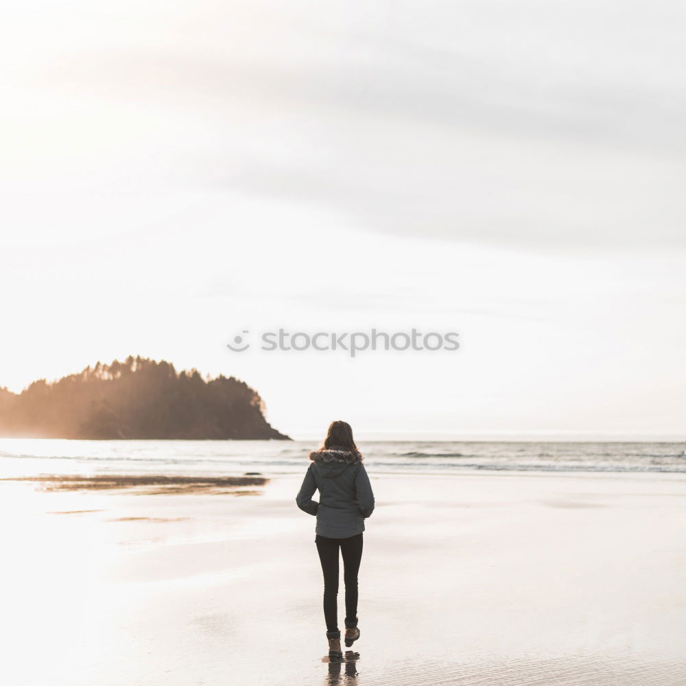 Woman on the beach looking at the horizon