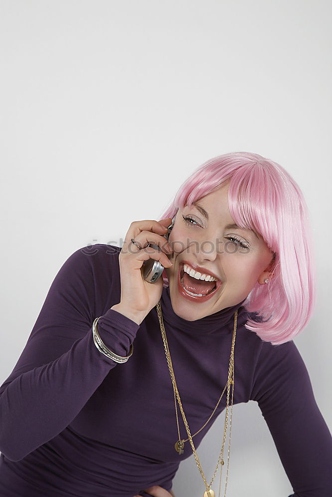 Similar – Young woman with pink hair is sticking out her tongue