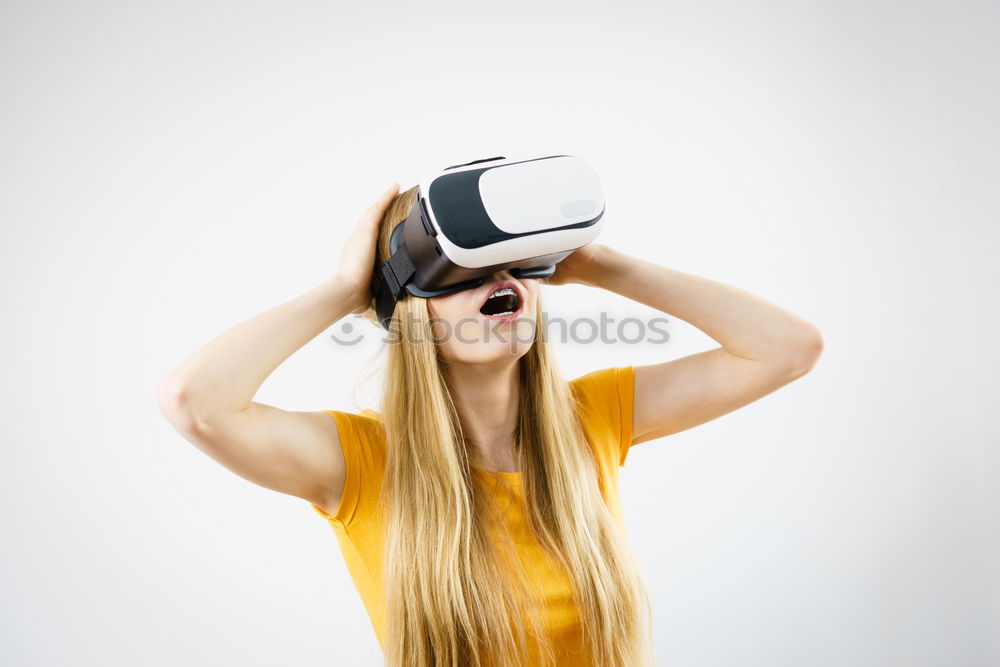 Similar – Image, Stock Photo Boy with virtual reality glasses on colorful background. Future technology, VR concept