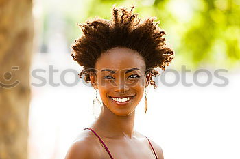 Similar – Black woman with afro hairstyle smiling in urban park.