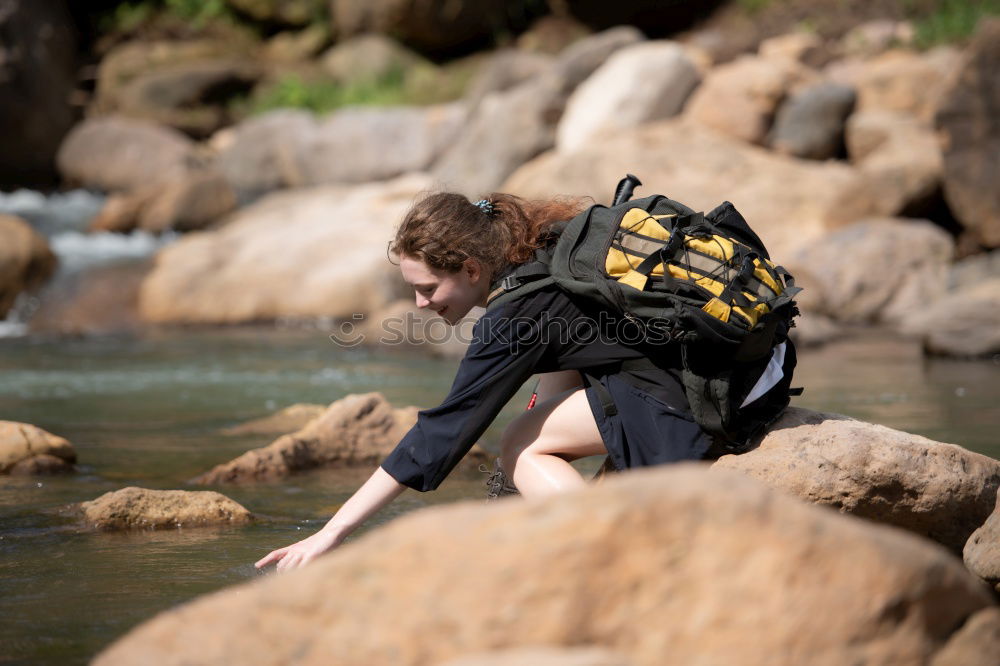 Similar – Young boy taking pure water from a river