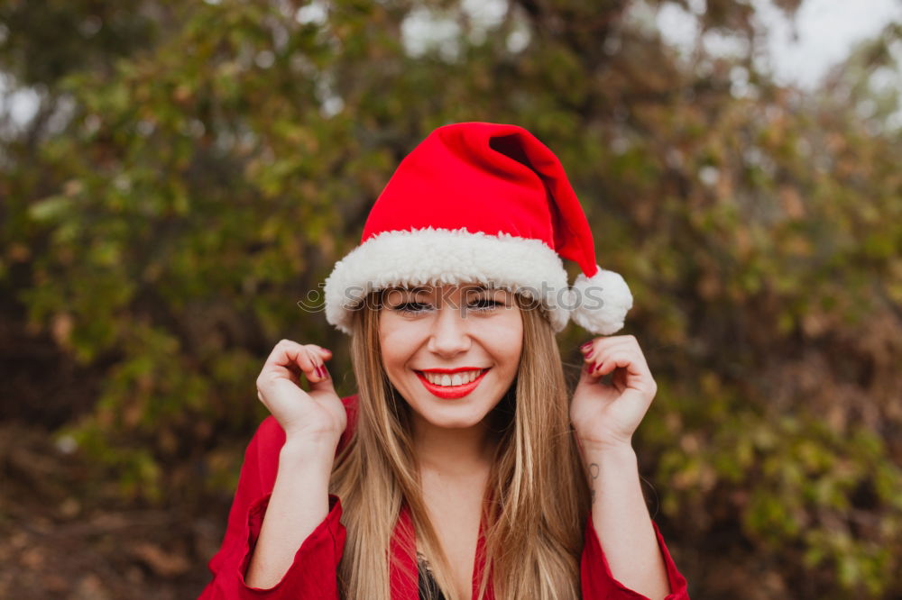 Image, Stock Photo Young woman with Christmas hat in the forest