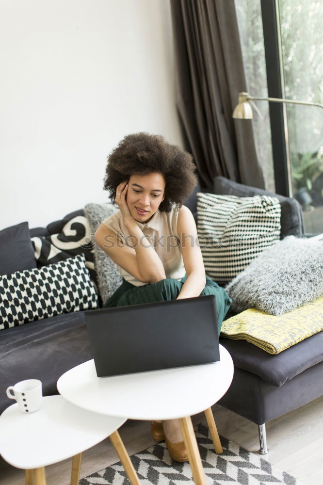 Similar – african happy woman lying on couch with laptop