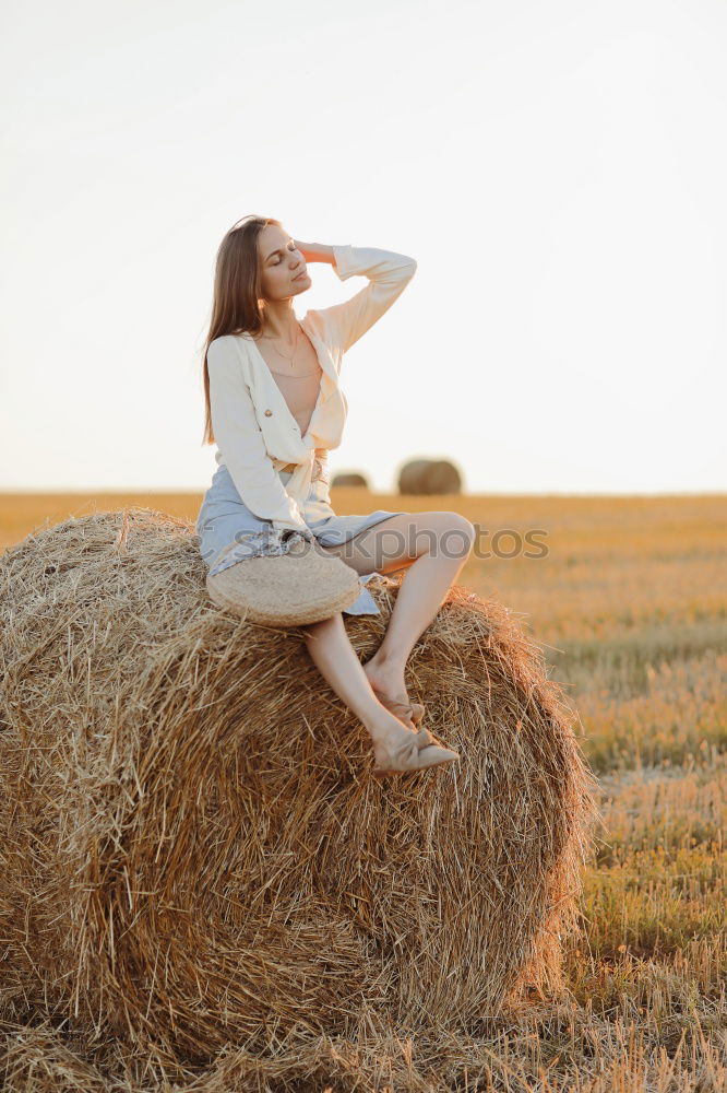 Similar – Woman in big round hat in middle of wheat field