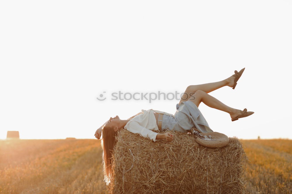 Similar – Image, Stock Photo Hand holding a cowboy hat over a field of wheat