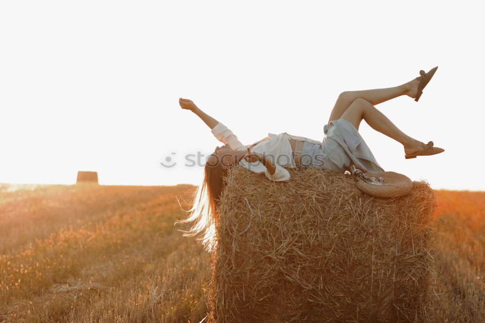 Similar – Hand holding a cowboy hat over a field of wheat