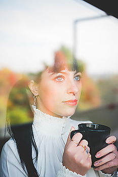 Similar – Dreaming girl looking away in window